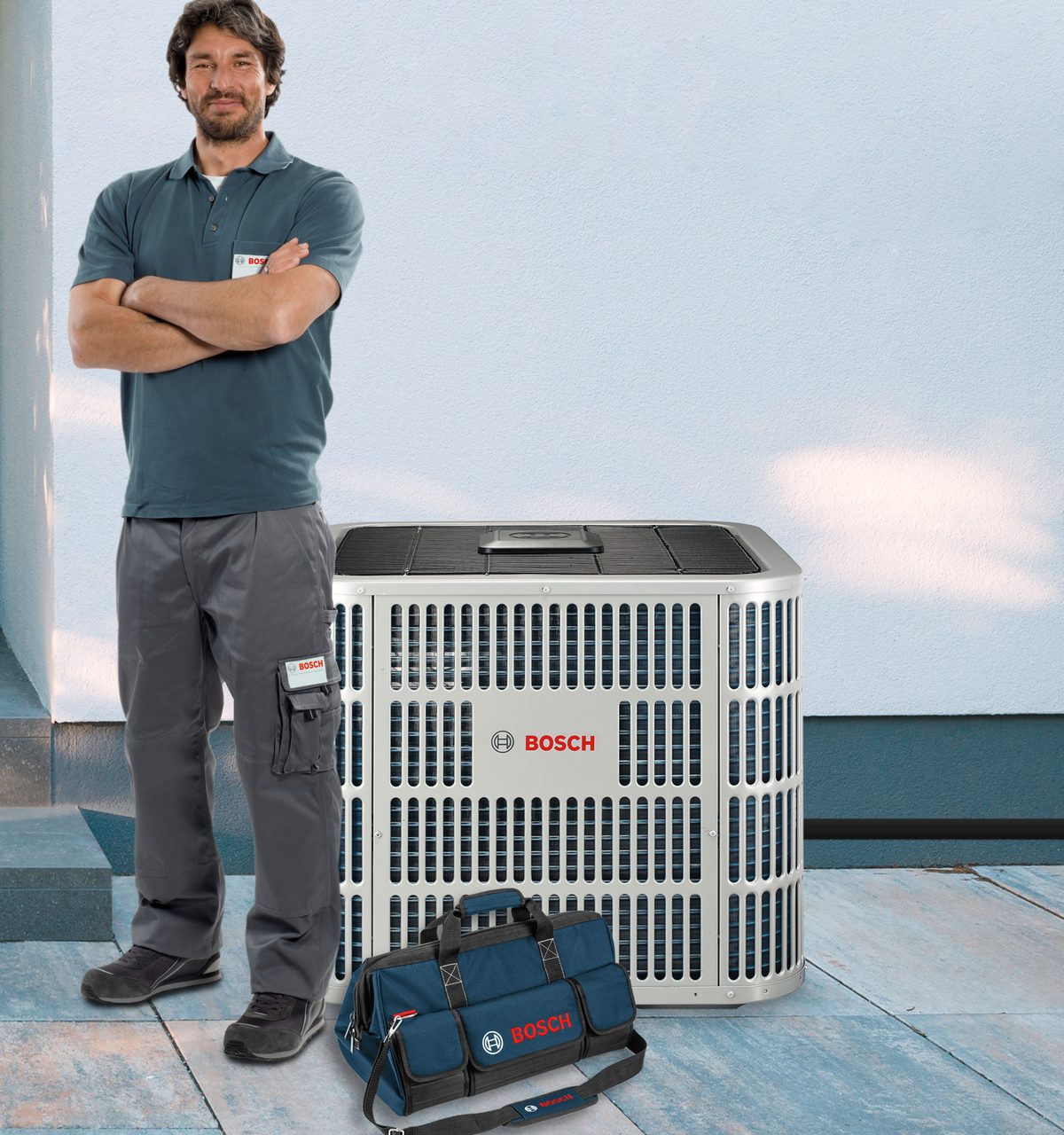 Bosch technician beside a high-efficiency Bosch heat pump condenser